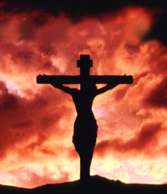 a silhouette of Jesus on cross